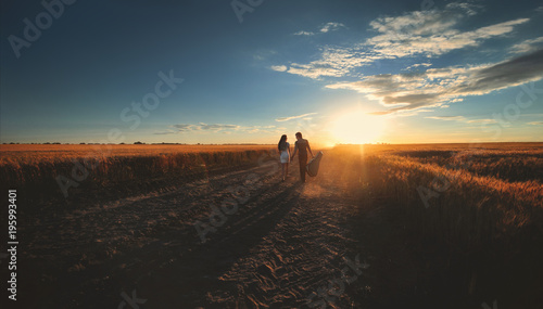 Photography A couple in love go hand in hand to meet the sunset