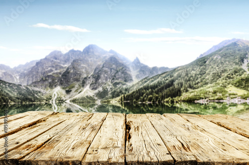 Desk of free space and landscape of lake and mountains 