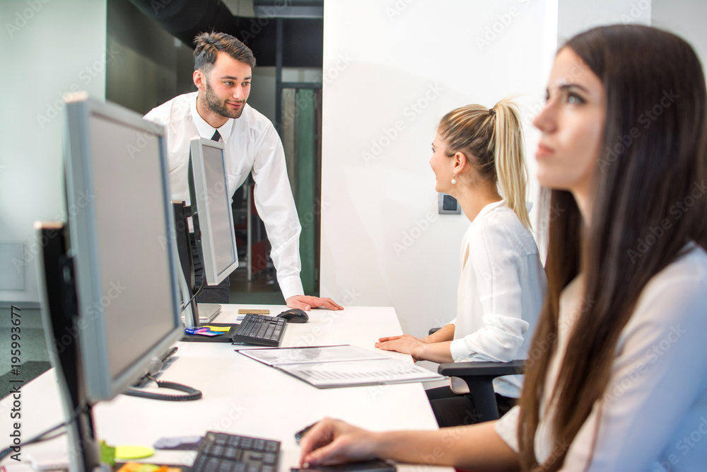 Busy businessman in office reception area talking with secretary Busy businessman in office reception area talking with secretary