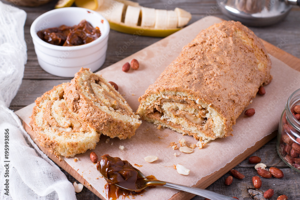 Homemade biscuit roll with cream, banana and peanuts Homemade biscuit roll with cream, banana and peanuts