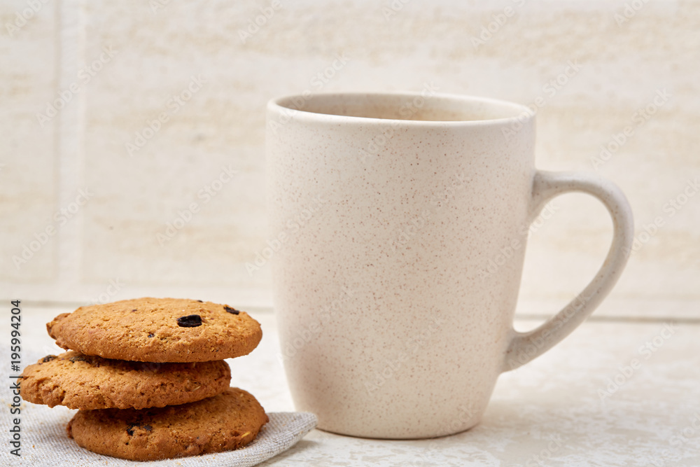 Close-up white cup of coffee with chocolate chip cookies on white background, top view Close-up white cup of coffee with chocolate chip cookies on white background, top view