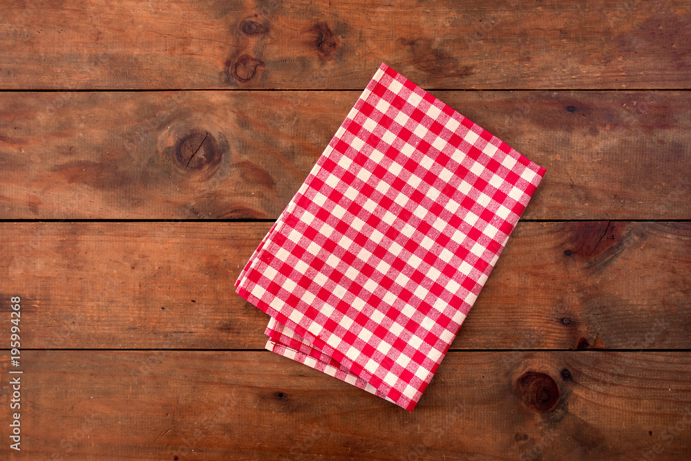 Red classic Checkered tablecloth on wooden table, background with copy space Red classic Checkered tablecloth on wooden table, background with copy space