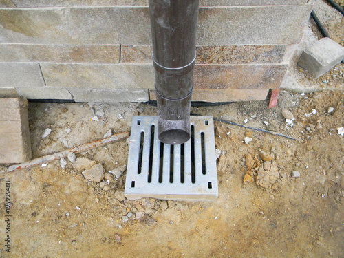 Close up on roof gutter downspout drain pipe with metal grainage. photo