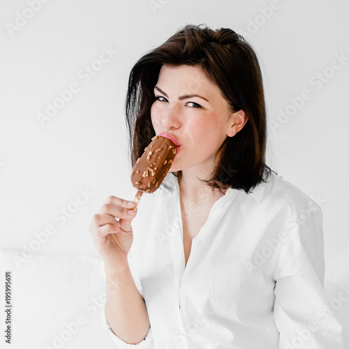 Young pretty woman   eating ice cream