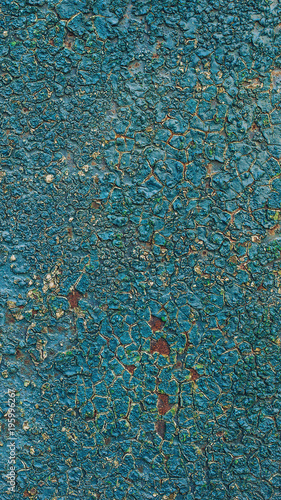 Old rusty metal background with blue paint flaking texture.