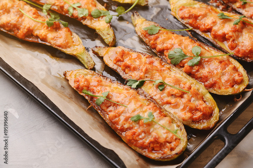 Baked stuffed zucchini with meat in a pan