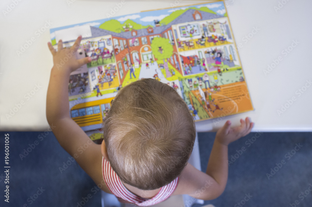 Adorable 2 years boy discovering pop-up book stories Adorable 2 years boy discovering pop-up book stories