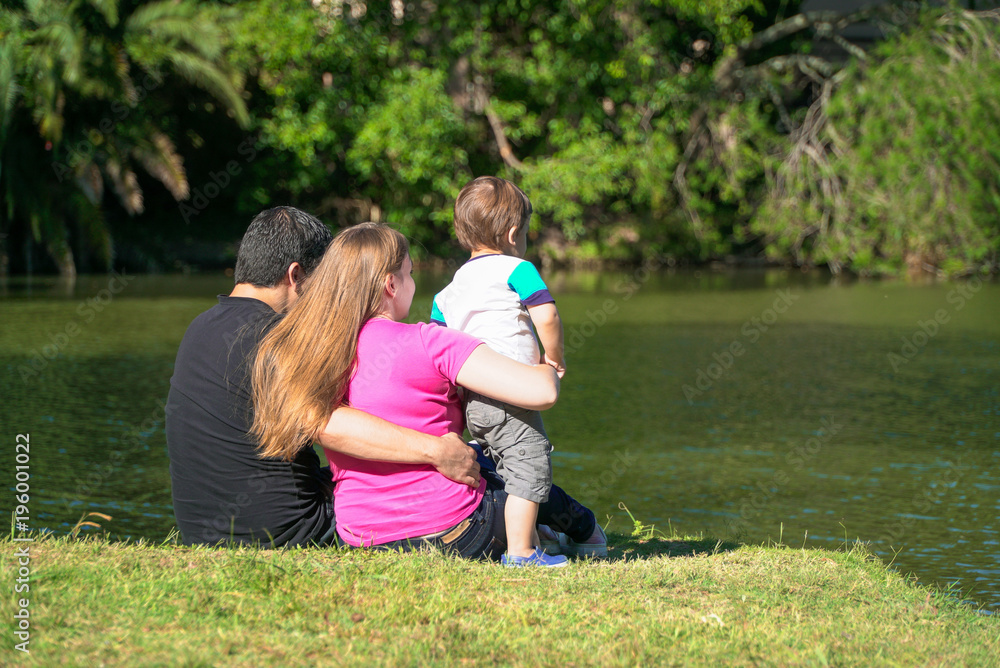 family sitting by the lake