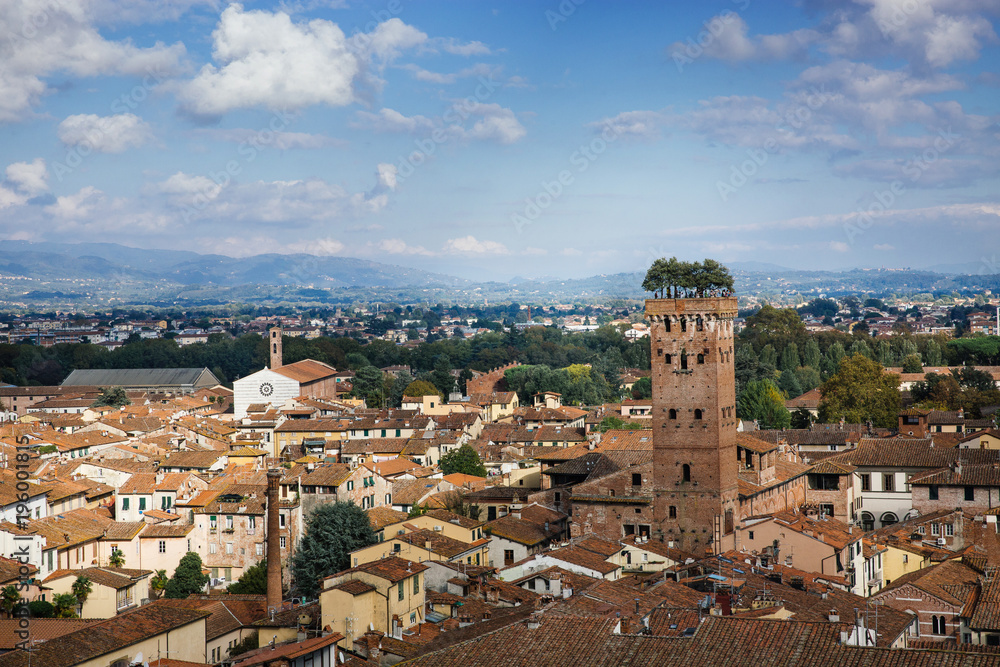 Scenic view of Guinigi Tower with garden on the top from Torre delle Ore. Location Lucca, Tuscany, Italy. Picturesque travel postcard.