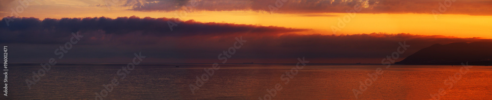 Panorama of the sea sunset, cloudscape. Golden and purple tones, beautiful contrast. Fantastic evening over Black sea
