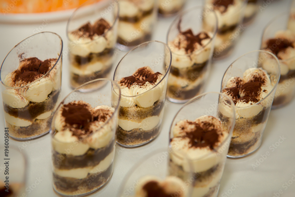set of tiramisu desserts rowed on table set of tiramisu desserts rowed on table