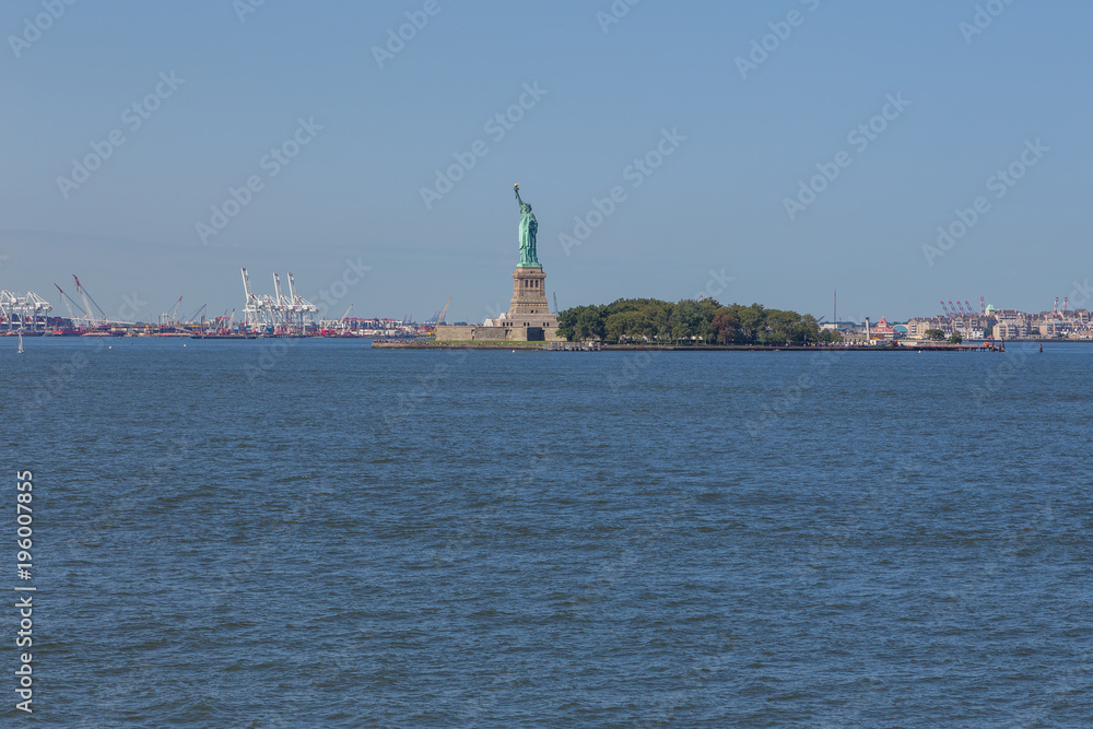 Statue of Liberty and panoramic view of Manhattan City skyline.
