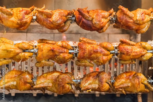 Grilled chickens on a spit, background
