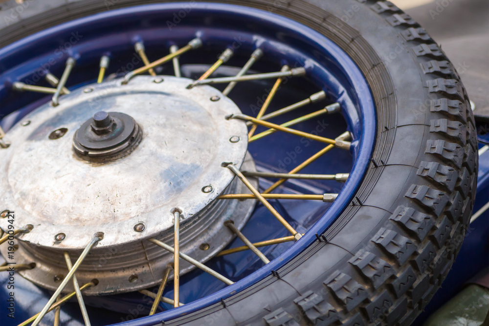 Obraz premium Tire motorcycle wheel with metal spokes vintage car close-up