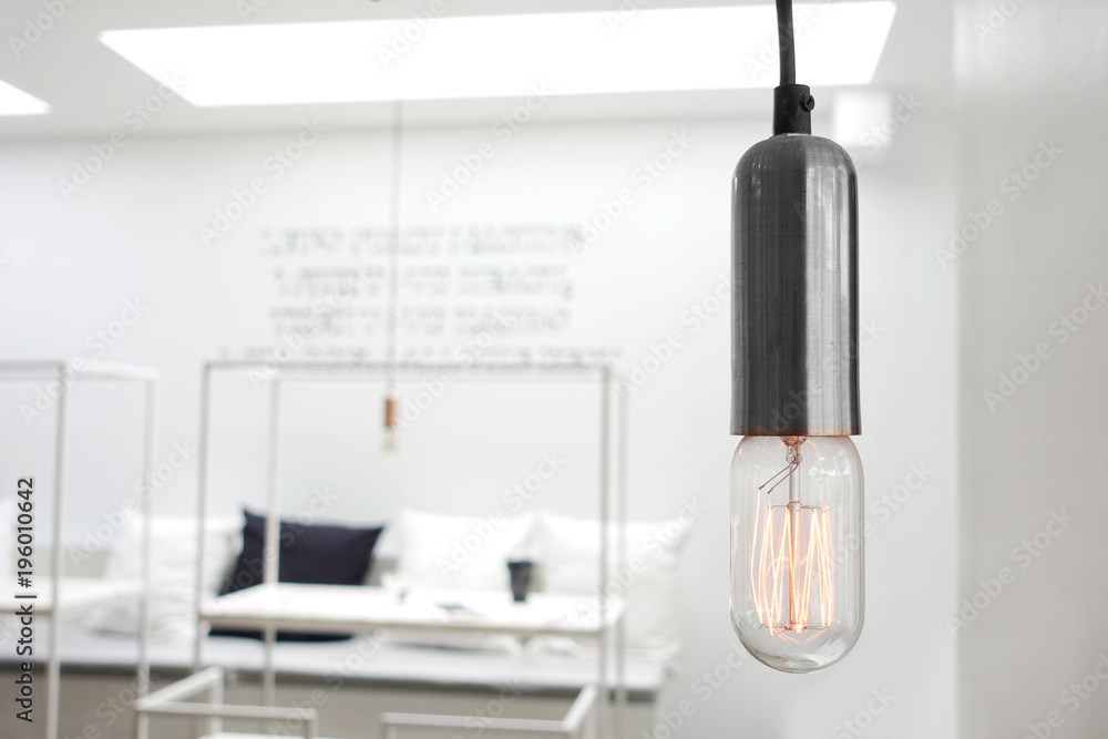 Modern stylish down light hanging in white minimalist room Modern stylish down light hanging in white minimalist room