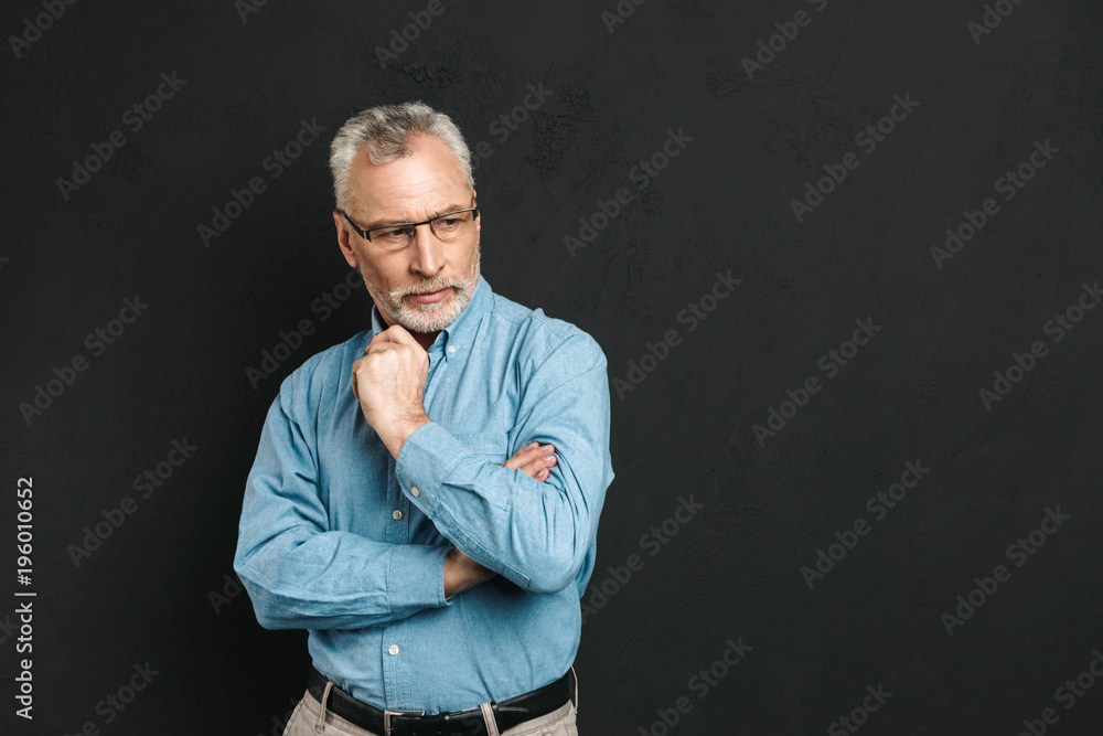 Portrait of a pensive mature man dressed in shirt Portrait of a pensive mature man dressed in shirt