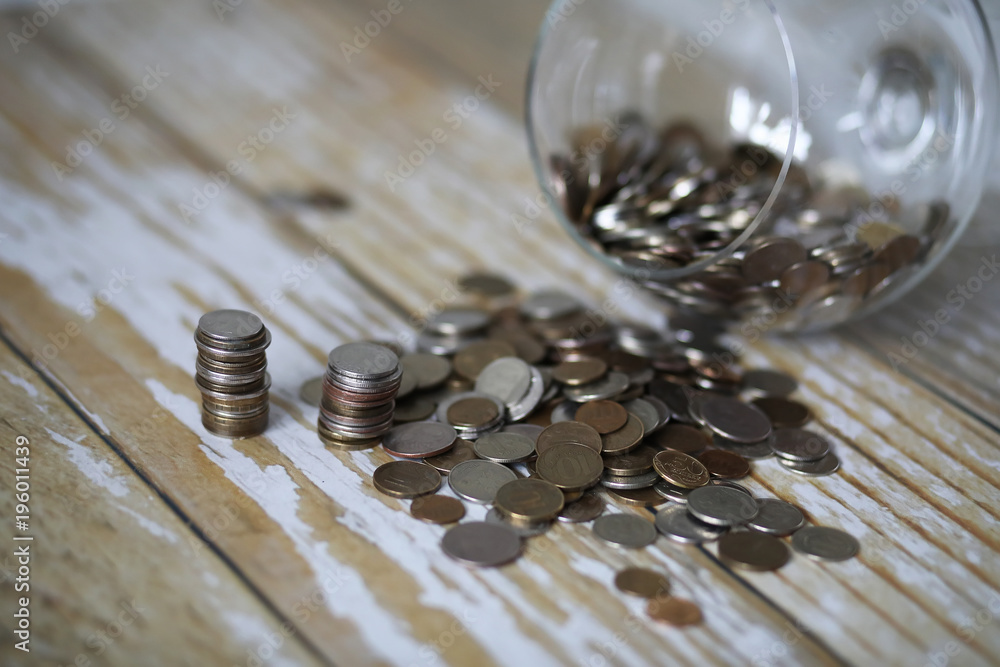 Accumulated coins stacked in glass jars Accumulated coins stacked in glass jars