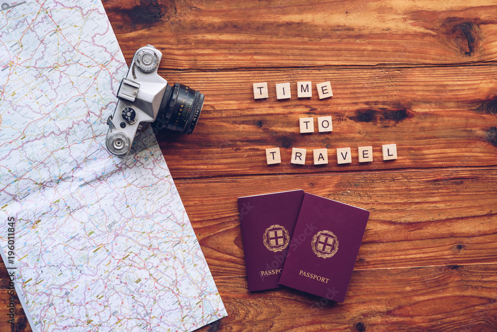 Fototapeta premium Time to travel words made from wooden letters. Travel concept