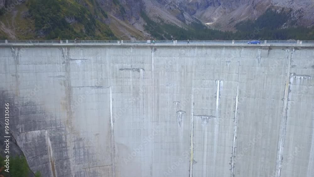 Mountain dam scenic drone shot - artificial lake. Cinematic aerial view of a dam with artificial lake Mountain dam scenic drone shot - artificial lake. Cinematic aerial view of a dam with artificial lake