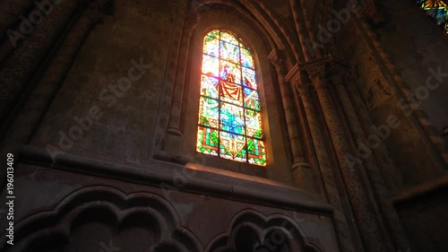 Golden sun rays through stained glass in a church - moody feeling. Beautiful cinematic shot - house of god