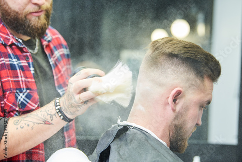 Bilde på lerret Barber or hair stylist at work. Hairdresser using talc