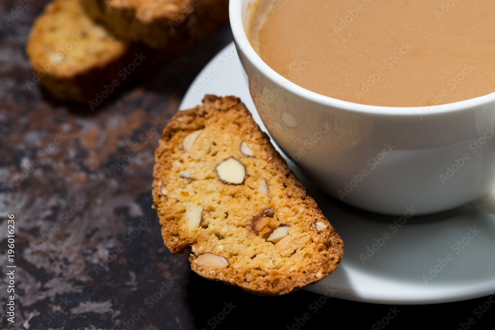 cup of coffee with milk and Italian cookies cantucci, closeup selective focus cup of coffee with milk and Italian cookies cantucci, closeup selective focus