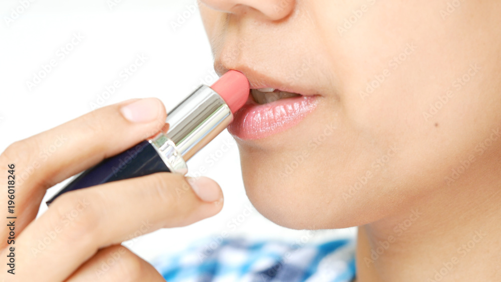 Woman applying Lipstick