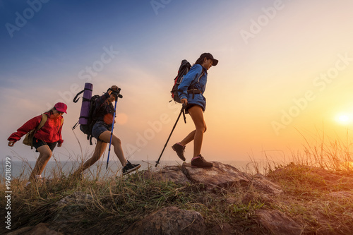 Lady hikers walking in the mountains. photo
