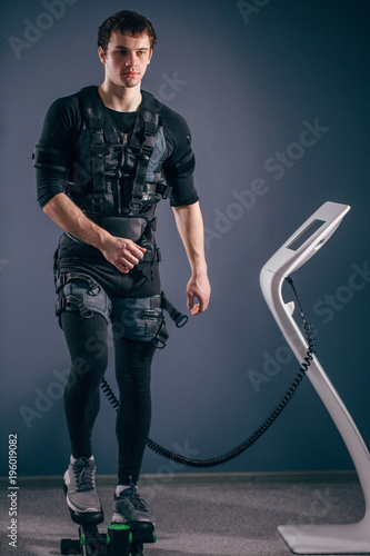 Caucasian man training on stepper with electric muscle stimulation photo