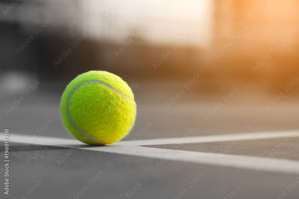 Close up tennis ball on the courts background