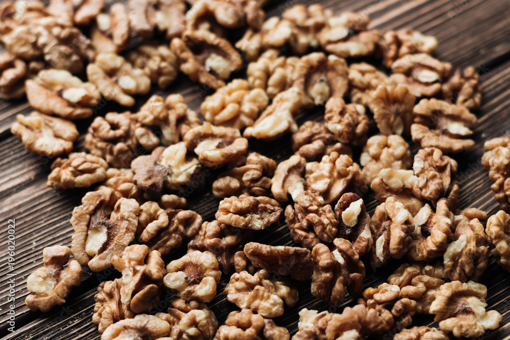 Pile of shelled walnuts on wooden background, healthy eating concept Pile of shelled walnuts on wooden background, healthy eating concept