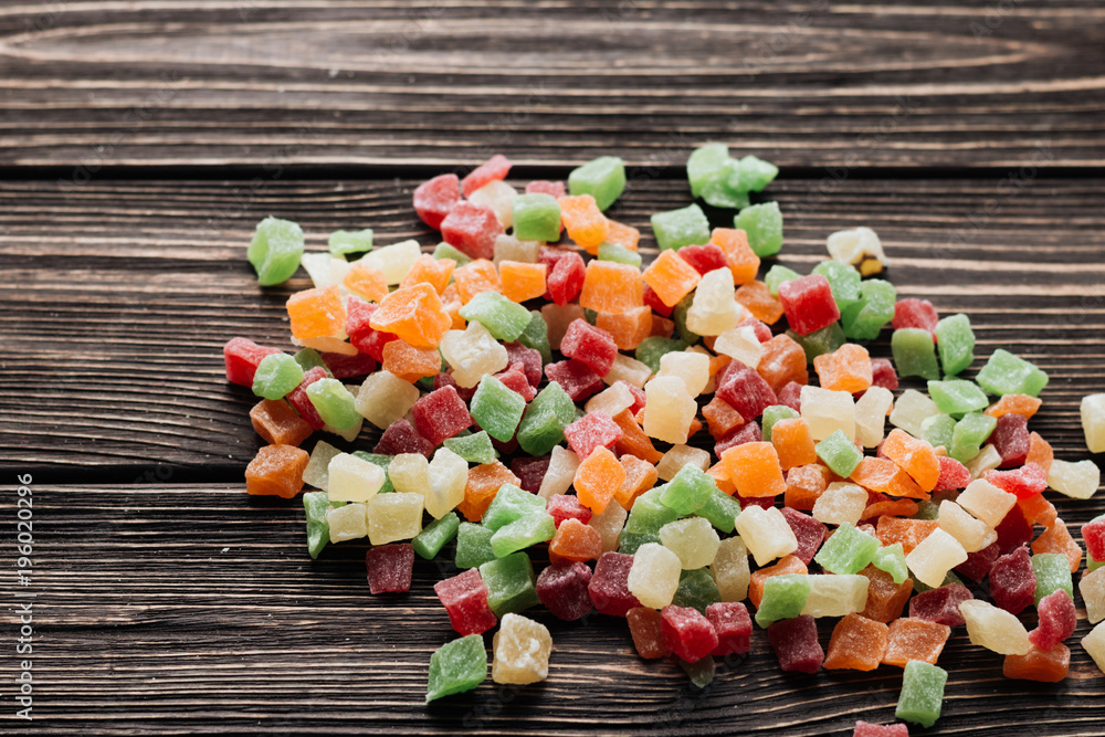 Pile of sweet colorful candies fruits on wooden table Pile of sweet colorful candies fruits on wooden table