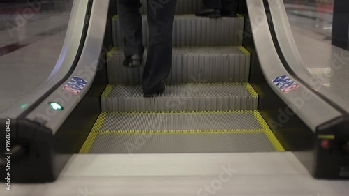 Two men climb the stairs upward