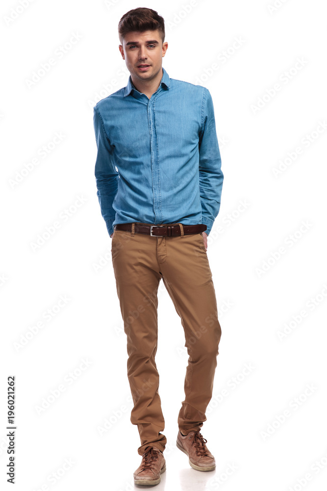 smiling casual man standing with hands in his back pockets smiling casual man standing with hands in his back pockets