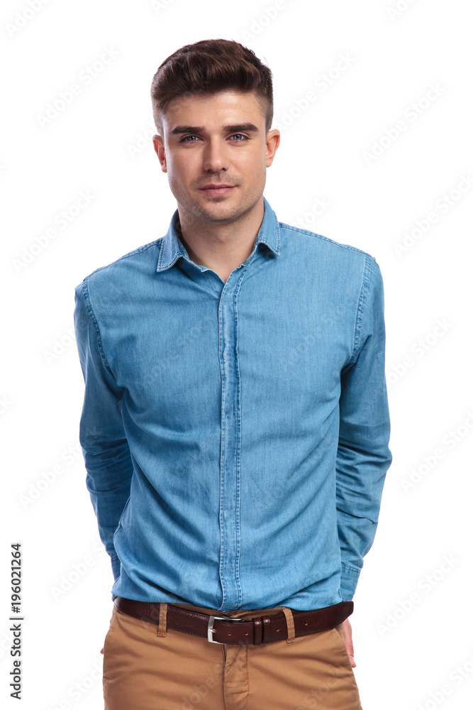young casual man with hands in his back pockets young casual man with hands in his back pockets