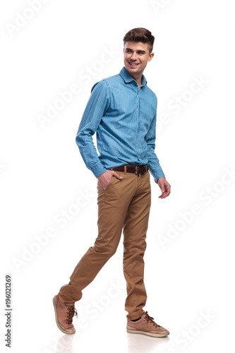 side view of a happy relaxed casual man walking