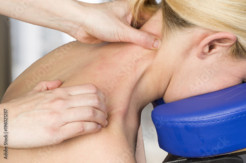 Картината върху платно Chiropractor, physiotherapist giving a back massage to a woman patient
