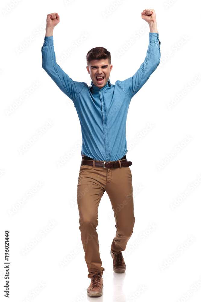 excited young casual man celebrating success excited young casual man celebrating success
