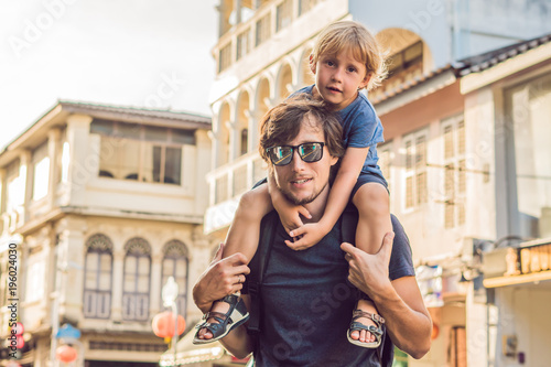 Dad and son are tourists on the Street in the Portugese style Romani in Phuket Town. Also called Chinatown or the old town
