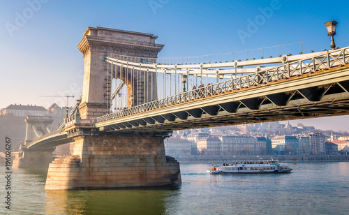 Beautiful view of the Chain Bridge over the Danube with boat in Budapest, Hungary