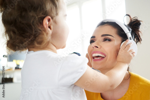 Cheerful mother playing with her daughter
