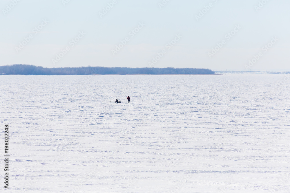 Winter fishing on the river or lake. The fishermen on the ice.
