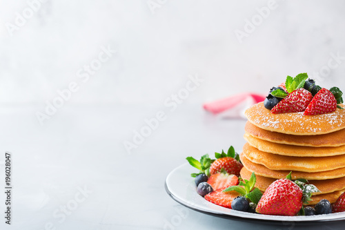 Stack of homemade pancakes for breakfast with berries