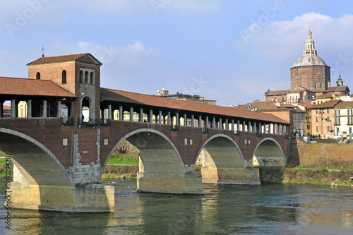 Italy - Pavia - The Covered Bridge (also called Ponte Vecchio) on the ticino with the Cathedral of the city in the background