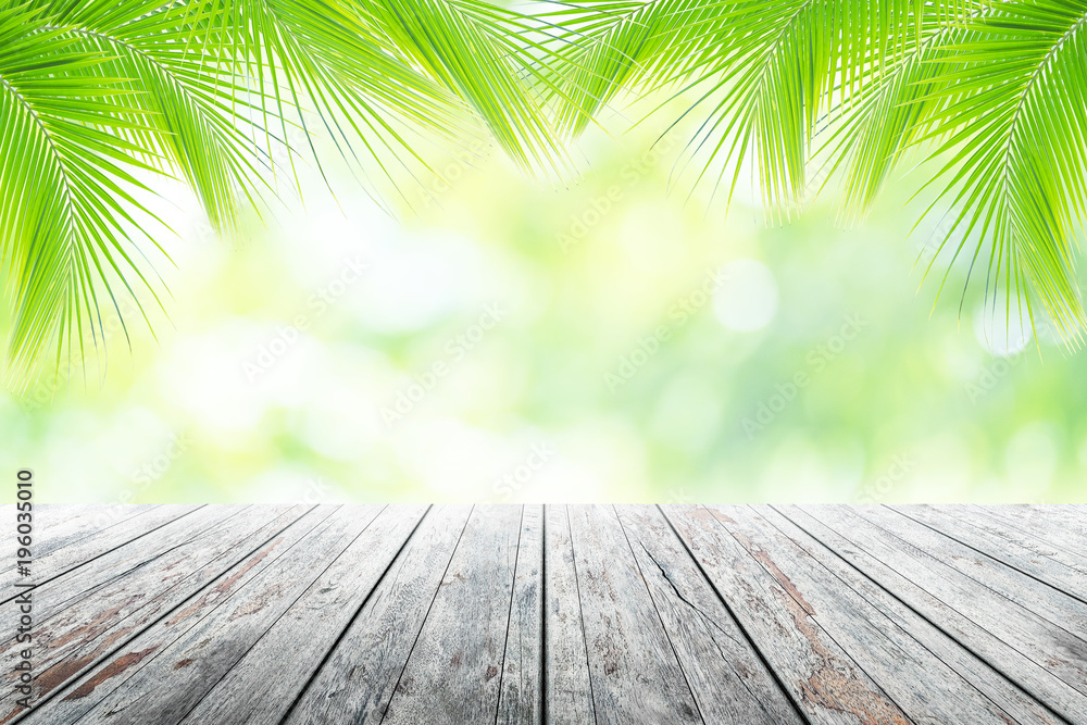 Empty wooden table with party in coconut leafs in resort garden background blurred. Empty wooden table with party in coconut leafs in resort garden background blurred.