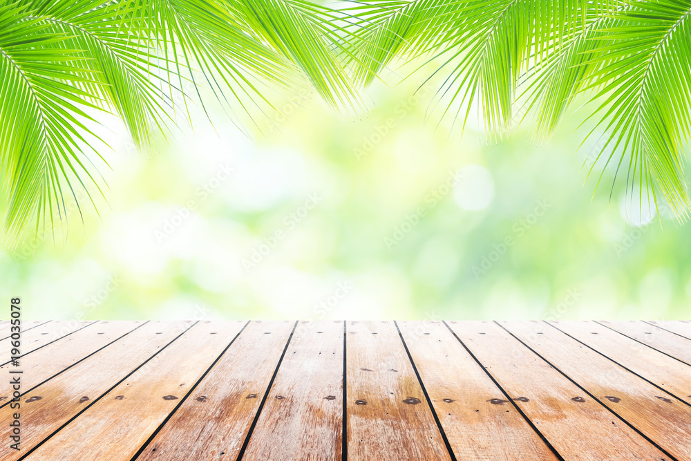 Empty wooden table with party in coconut leafs in resort garden background blurred. Empty wooden table with party in coconut leafs in resort garden background blurred.