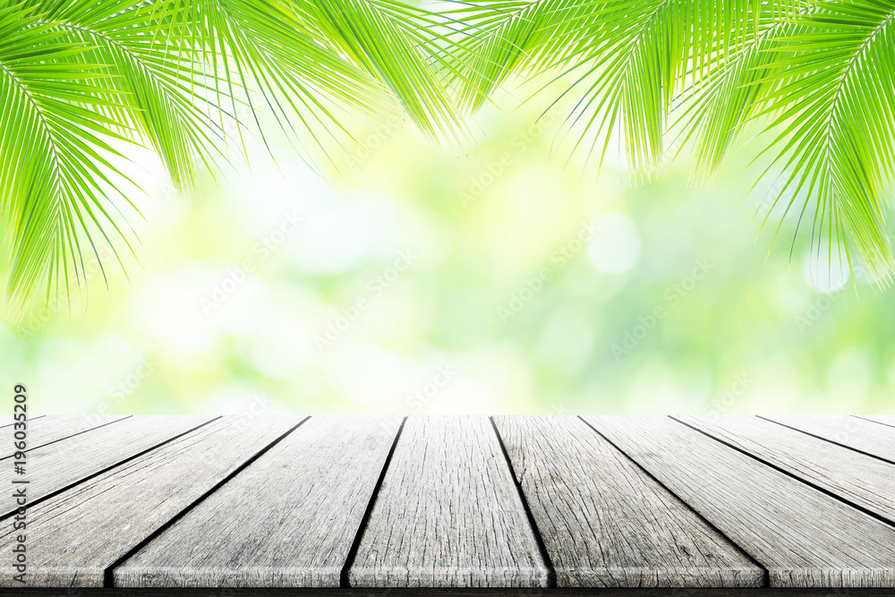 Empty wooden table with party in coconut leafs in resort garden background blurred. Empty wooden table with party in coconut leafs in resort garden background blurred.