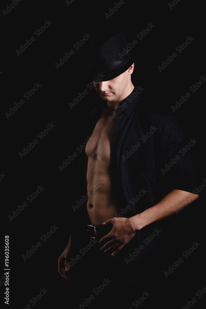 strong, athletic man on a black background