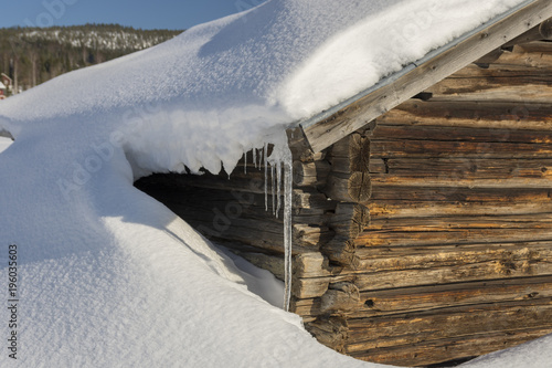 Wallpaper Mural Old barn with one side covered with snow and with a icicle from the roof Torontodigital.ca
