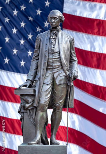 Isolated statue of George Washington, Independence Hall, Philadelphia, PA. The United States flag is in background.